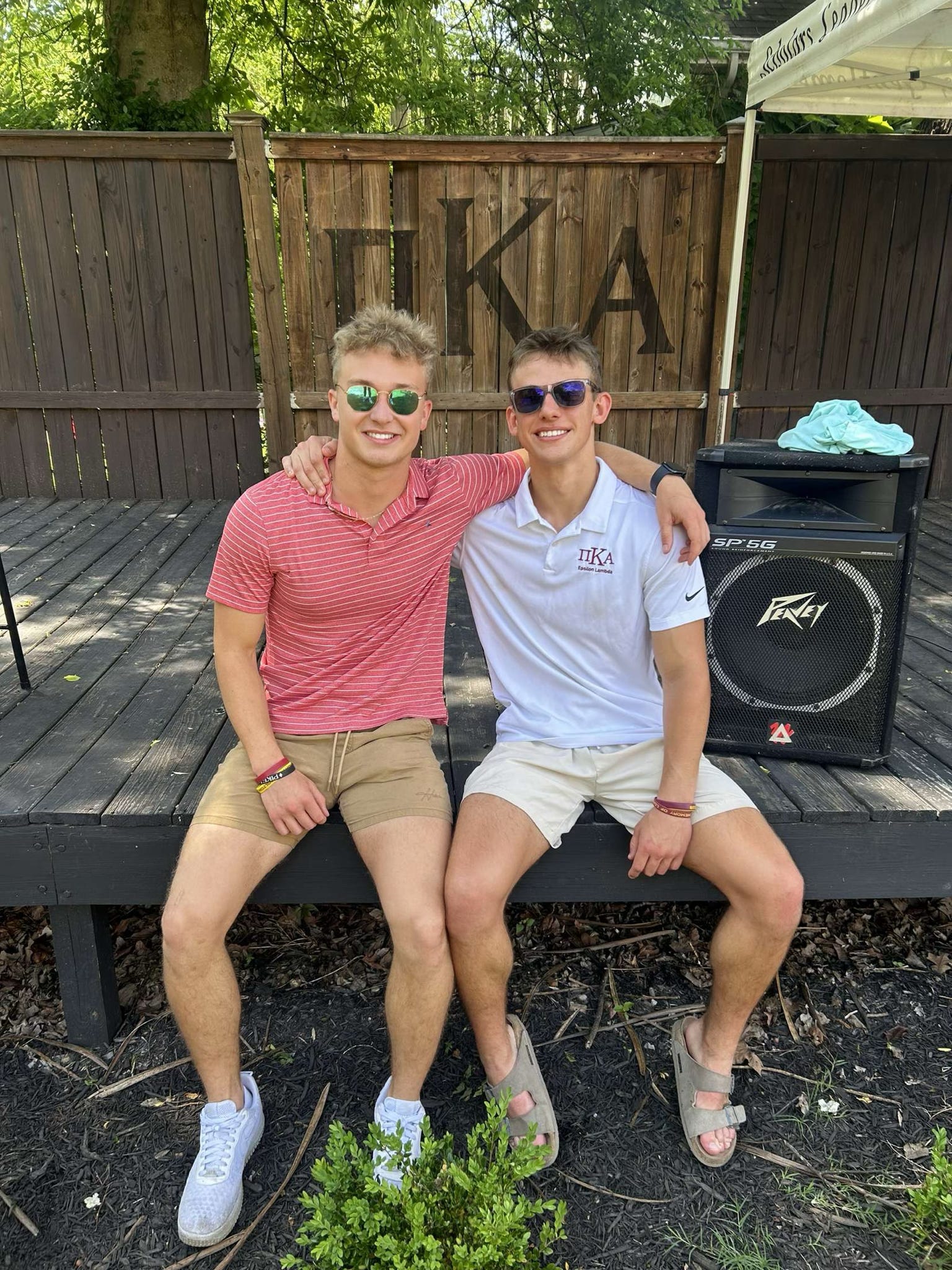 Two PIKE members sitting outside