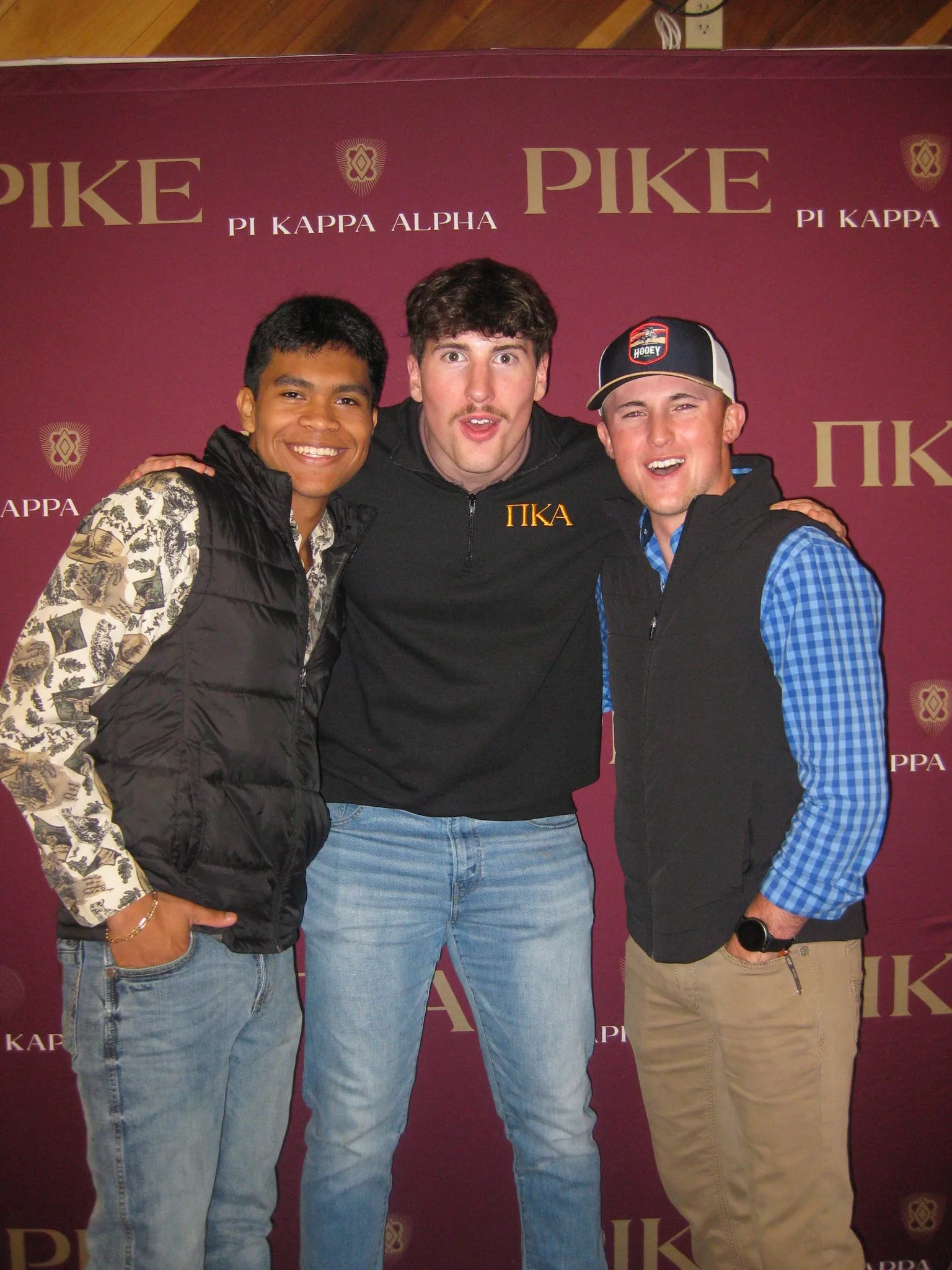 Three Pi Kappa Alpha members at chapter event